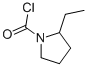 1-Pyrrolidinecarbonyl chloride, 2-ethyl- (9CI)